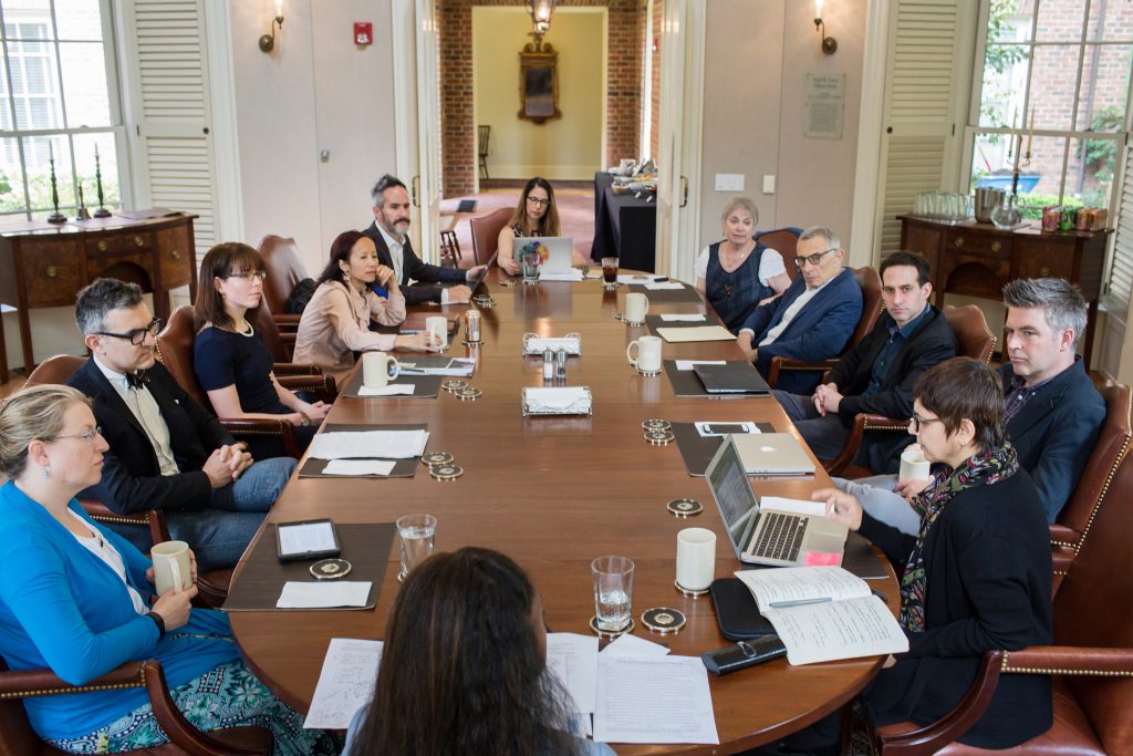 Twelve people (as part of the spring 2017 Faculty Fellowship cohort) sit around the large table in the Fellows Room.