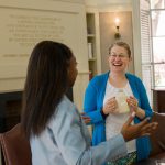 Michele Berger, Faculty Fellowship Program Director talks with a Fellow at Hyde Hall's Fellows Room.