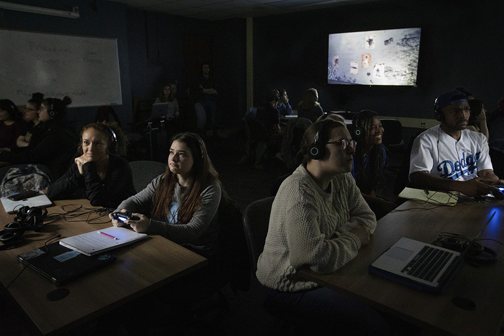 Students play "Layers of Fear" during their "Horror and the Global Gothic: Film, Literature, Theory" class in the Greenlaw Gameroom on January 31, 2020.