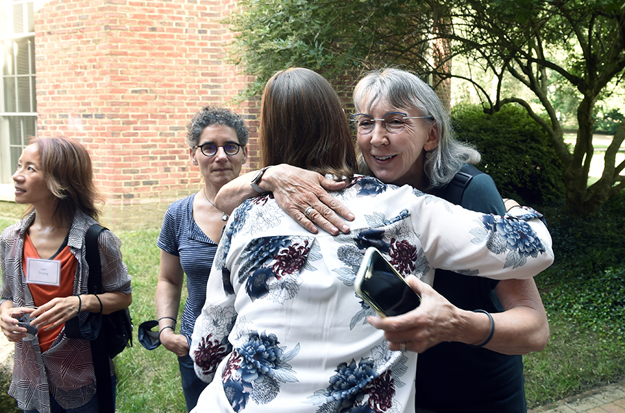 Florence Babb gives a hug to Courtney Rivard on the way into Hyde Hall for the Welcome Reception.