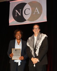 Patricia Parker receives a plaque and poses with the NCA president Walid Afifi.